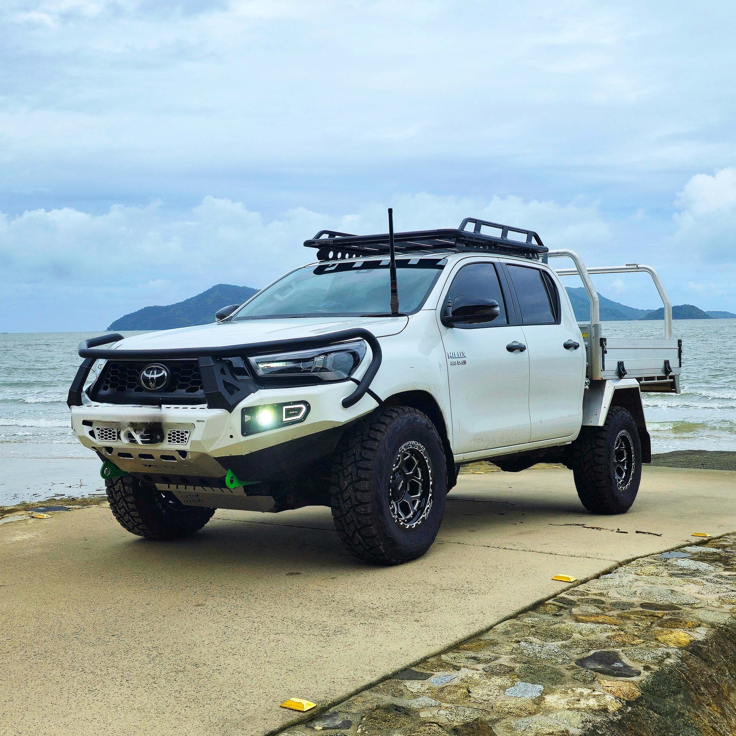 2023 Toyota Hilux with H1-HEX LFT Wheels side angle 4x4 17x9 0mm offset White