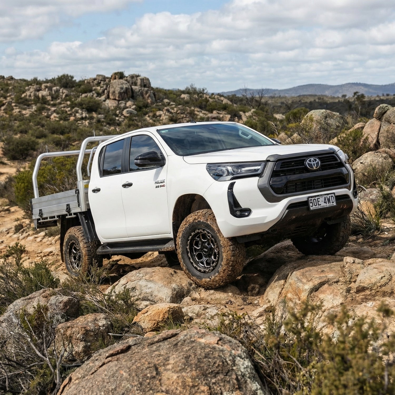 2024 Toyota Hilux with H1-HEX LFT Wheels side angle 4x4 17x9 0mm offset White